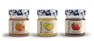 3 mini Folláin jars with 3 different flavours, whiskey marmalade, lemon curd and strawberry each with an illustrated floral lid