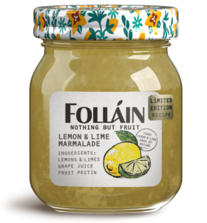 Glass jar of Folláin Lemon and lime marmalade with a floral illustrated lid and ingredients label including lemon, lime, grape juice and fruit pectin